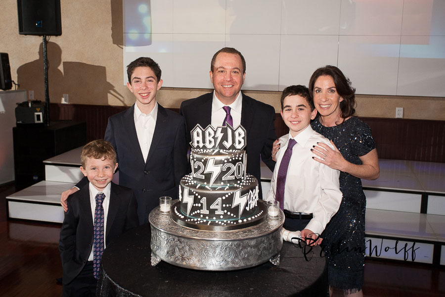 The family poses with the custom Bnot Mitzvah cake at Temple or Elohim Jericho Long Island