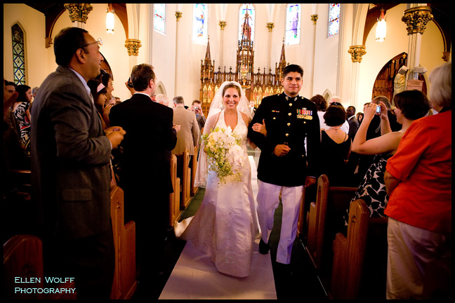 The bride and her  groom make their way up the aisle at St James Church in Manchester CT
