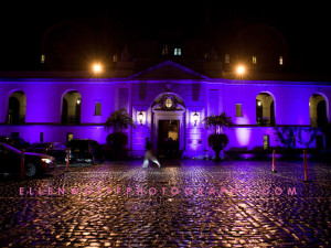 rainy night at Oheka Castle lit up in purple