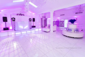 white sweet 16 party room bathed with purple light